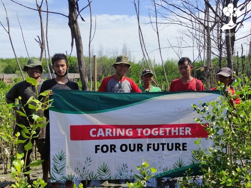 Foto bersama setelah penanaman mangrove dengan banner bertuliskan SYCA x LindungiHutan.
